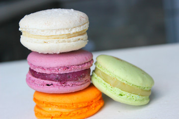Colorful French or Italian macaroon stack cakes / Macaroon cakes. Assorted macaroon cakes stacked on top of each other on a light background. Copy space. Delicious dessert.