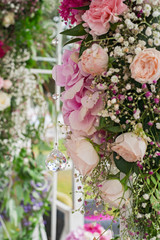 Photo of pink and white flowers, green leaves. Wedding decoration. Crystal.