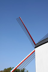 Windmill in Bruges Belgium against a clear blue sky