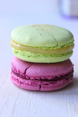 Colorful French or Italian macaroon stack cakes / Macaroon cakes. Assorted macaroon cakes stacked on top of each other on a light background. Copy space. Delicious dessert.