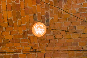 Vintage light bulb on brick ceiling background