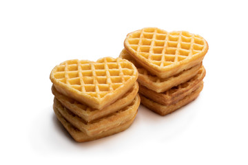Stacks of heart shaped waffles isolated on white