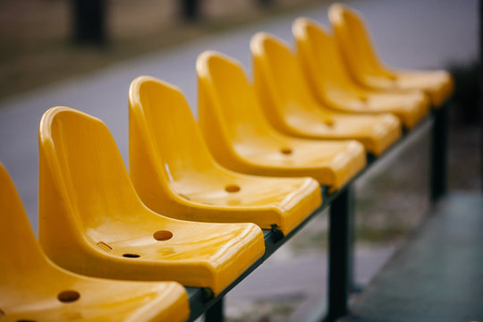 Empty yellow seats on the sport stadium