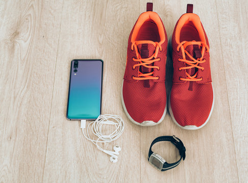 Cool Runner Sneakers With Smartphone, Earphones And Fitbit Sport Watch. Ready For Training, Healthy Life