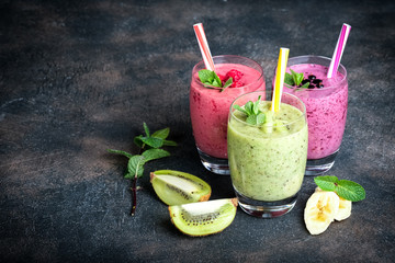 Fruit and berry smoothie blend at home on a dark background copy  space.