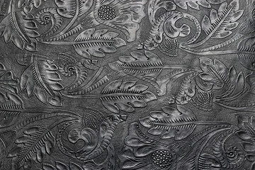 Embossed shiny black leather with the floral motif