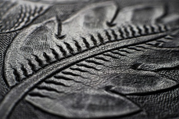 Embossed shiny black leather with the floral motifs - close up to the detail