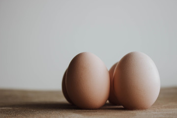 Fresh farm eggs on a wooden rustic background. Candid style on Easter