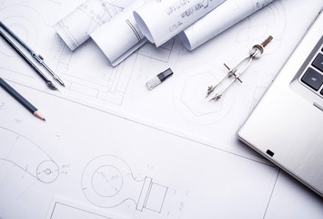 Laptop with several drawing tools on drawings