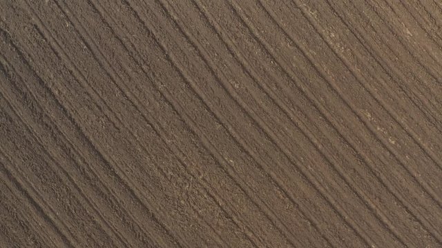 Soil after plowing from above 4K drone video