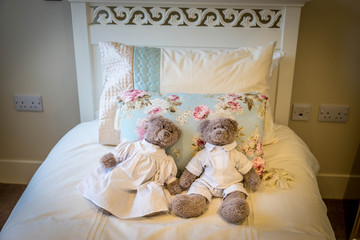 Two teddy bears lying on the bed. Shabby Chic Interior Design 