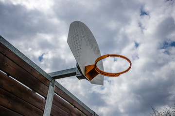 Basketball hoop with a cloudy sky