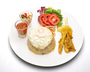 Fried rice with fried egg with grilled pork and salad .food isolated on white background .