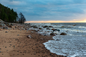 storm weather on the beach by rocky sea shore