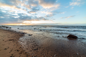 storm weather on the beach by rocky sea shore