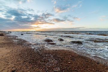 storm weather on the beach by rocky sea shore