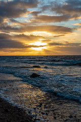 storm weather on the beach by rocky sea shore