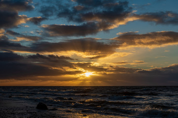Fototapeta premium storm weather on the beach by rocky sea shore