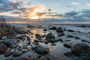 storm weather on the beach by rocky sea shore