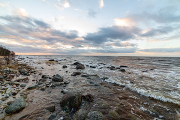 storm weather on the beach by rocky sea shore