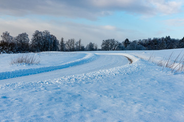 snowy winter road covered in ice and snow