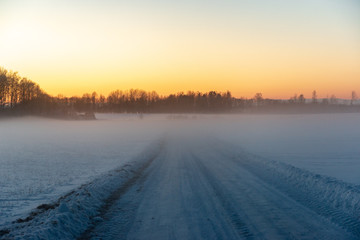 Fototapeta premium snowy winter road covered in ice and snow