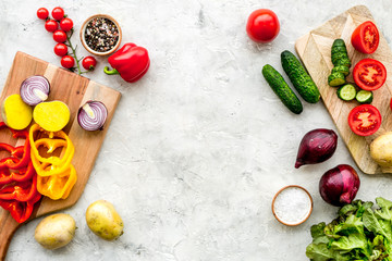 cooking with raw vegetables on light background top view