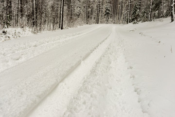 snowy winter road covered in ice and snow