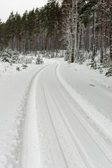 snowy winter road covered in ice and snow