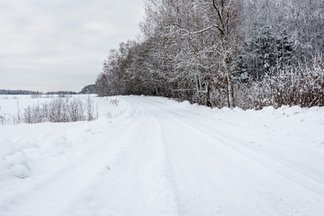 snowy winter road covered in ice and snow