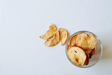 Healthy apple chips on white background, top view. Image with copy space.