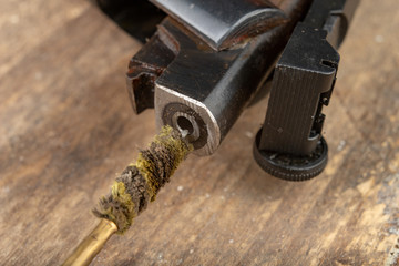 A pneumatic weapon on a wooden table on a shooting range. Shooting accessories needed for shooting sports.