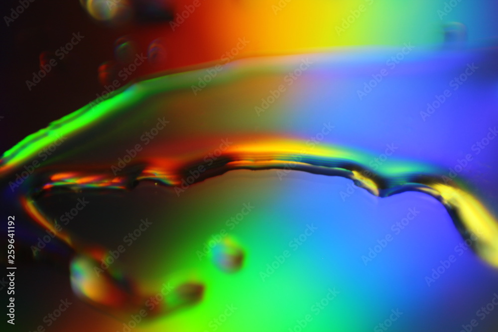 Poster abstract liquid colorful background with water droplets and splash on holographic surface