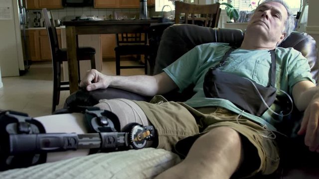 tilt to man wearing a leg brace in pain