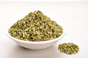 fennel seeds in bowl isolated on white background