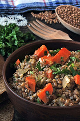 Homemade buckwheat porridge with vegetables in a bowl. Buckwheat diet concept. Healthy vegan food.