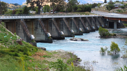 Defunct dam on Lake Wakapitu, Queenstown, New Zealand and replacement bridge