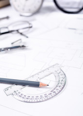 Pencil with a protractor against the background of the engineer's desk