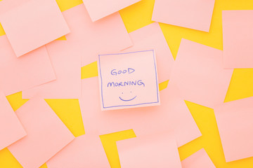 Hello Monday; text on sticky note on pink table. Top view.