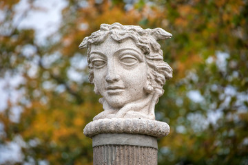 head monument in autumn park on background