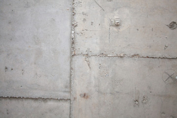 Formwork traces on concrete. Repair and construction or constructing. Concrete background. Grey color. Cement texture. Poor quality curve wall. Flaws, defects and cracks in the wall. .