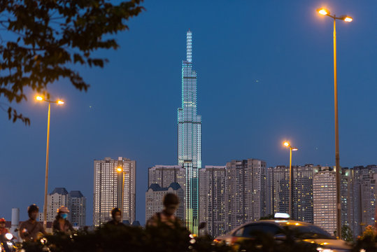 Night skyline of Vinhomes Central Park with Landmark 81 skyscraper with street lights and traffic in the foreground (blurred). Binh Thanh District, Ho Chi Minh City, Vietnam. © David Bokuchava