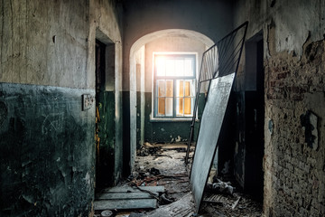 Fototapeta na wymiar Dark and creepy corridor of old abandoned hospital