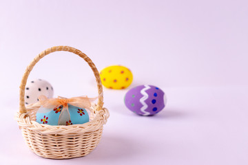 Happy Easter. Easter eggs concept. Closeup Easter eggs in the basket on white paper background.