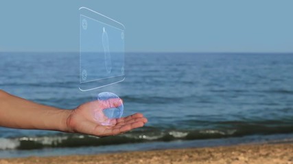 Male hands on the beach hold a conceptual hologram with bottle. A man with a holographic technology on the background of the sea - Powered by Adobe