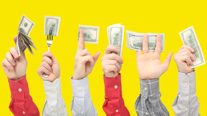 Men's hands holding dollar bills with money on yellow background