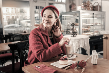 Relaxed lady enjoying atmosphere in cozy cafe