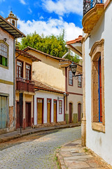 Facade of old houses built in colonial architecture with their balconies, roofs and colorful details in the historical city of Ouro Preto in Minas Gerais.