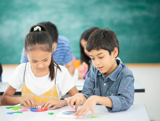 Group of Students study math with teacher in the classroom