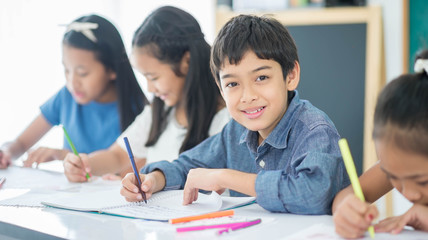 Asian primary student and teacher in the classroom